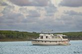 A DeFever anchored in a quiet remote cove